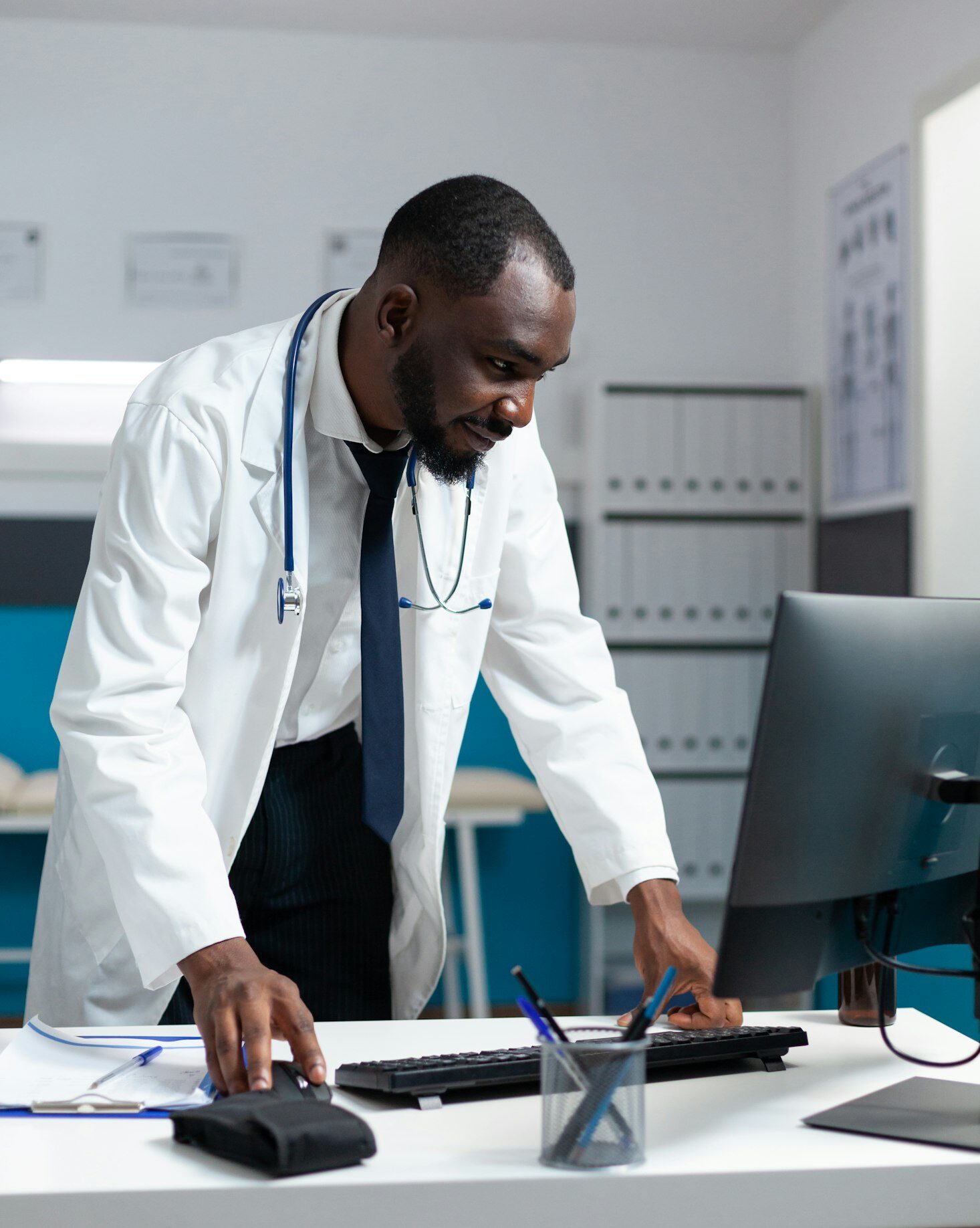 African american specialist doctor monitoring ill report on computer
